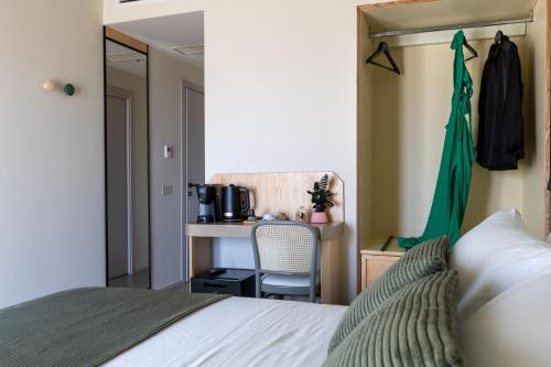 a bedroom with a bed and a desk with a chair at Domus Terravecchia in Agrigento