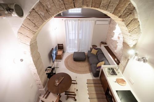 a living room with a couch and a table in a room at Loft Serisso in Trapani