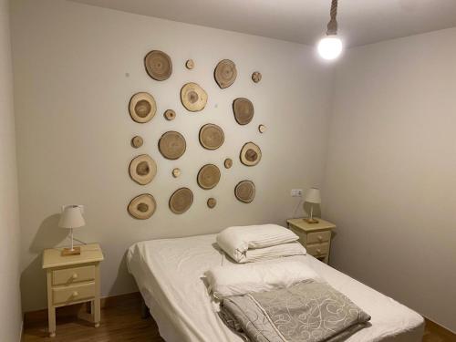 a bedroom with a bed and a bunch of hats on the wall at Apiedesierra - Caserio del Colmenar in Huétor Santillán