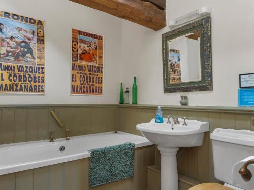 a bathroom with a tub and a sink and a mirror at Pass the Keys Stunning 4 Bed Barn Conversion Hot Tub in Lake Side