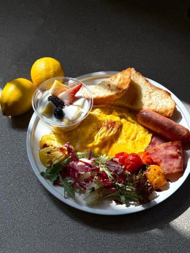 a plate of breakfast food with eggs sausage and toast at BuYuan Hotel - Near Wuhou Shrine, Chunxi Road,T aikooli, Tianfu Square, People's Park, Chengdu Museum, Very close to the Sichuan University , Exit C of Huaxiba on Metro Line 1,Provides Welcome refreshments ,Minibar,Laundry & Luggage delivery service in Chengdu
