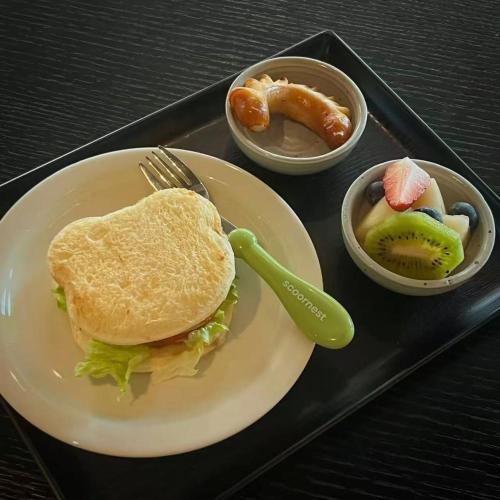 a tray with a sandwich and two bowls of food at BuYuan Hotel - Near Wuhou Shrine, Chunxi Road,T aikooli, Tianfu Square, People's Park, Chengdu Museum, Very close to the Sichuan University , Exit C of Huaxiba on Metro Line 1,Provides Welcome refreshments ,Minibar,Laundry & Luggage delivery service in Chengdu