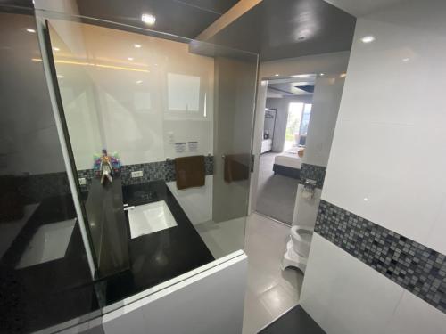 a bathroom with a sink and a mirror at Lalaguna Villas Luxury Dive Resort and Spa in Puerto Galera