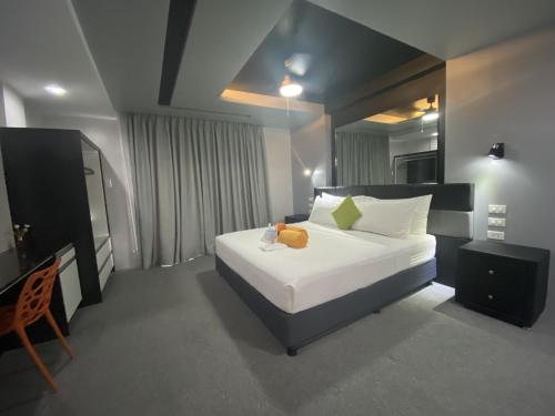 a bedroom with a bed with a teddy bear on it at Lalaguna Villas Luxury Dive Resort and Spa in Puerto Galera