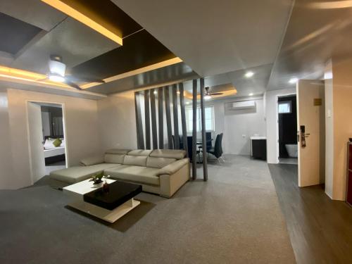 a living room with a couch and a table at Lalaguna Villas Luxury Dive Resort and Spa in Puerto Galera
