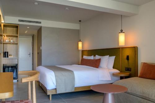 a bedroom with a large bed and a kitchen at Blue Sea Beach Affiliated By Melia in Stalida
