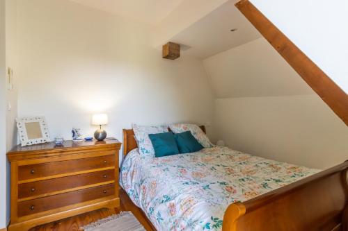 a bedroom with a bed and a wooden dresser at Belle Ferme Périgourdine in Sainte-Foy-de-Longas