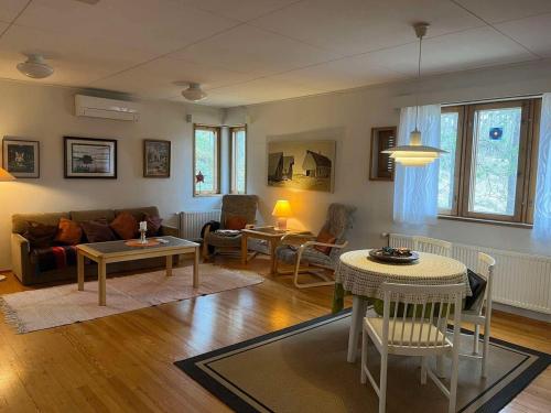 a living room with a couch and a table at Lakeside house in Sulkava in Sulkava