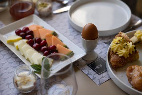 a table with two plates of food and an egg at Domus Terravecchia in Agrigento