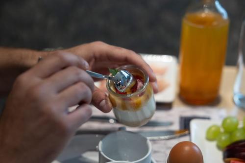 a person is holding a jar of sauce at Domus Terravecchia in Agrigento