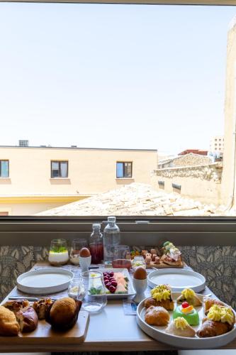 a table with plates of food and a window at Domus Terravecchia in Agrigento