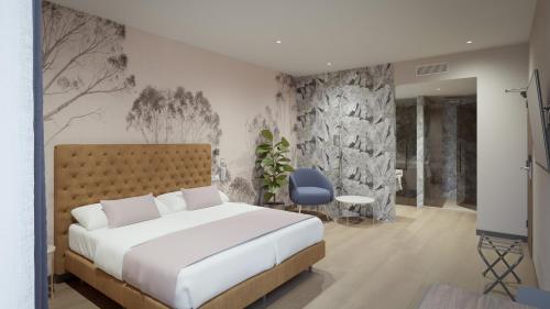 a bedroom with a white bed and a blue chair at ASA Molina Plaza in Molina de Segura