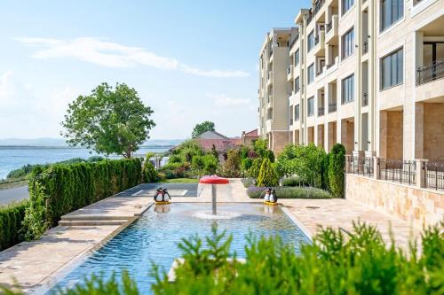 two penguins in a fountain in front of a building at Cosher - Gardenia Palace Apt 11 in Pomorie