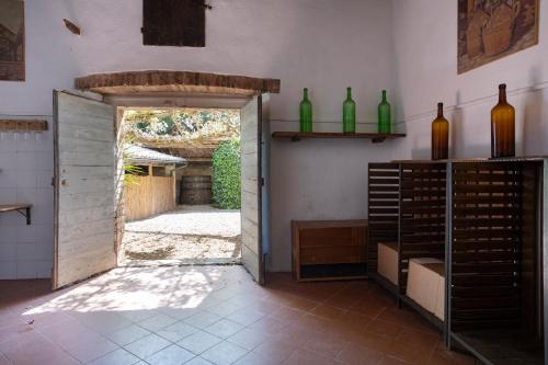an open door to a room with wine bottles at Borgo Villa Certano - Case Vacanza in Toscana in Siena