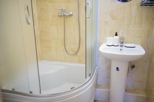 a bathroom with a shower and a sink at Край Неба in Slavske