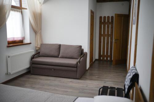 a living room with a couch and a window at Край Неба in Slavske