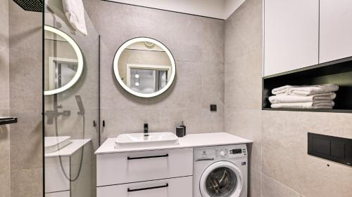 a bathroom with a washing machine and a sink at Rezydencja Niechorze 306 z Widokiem na Morze - 5D Apartments in Niechorze