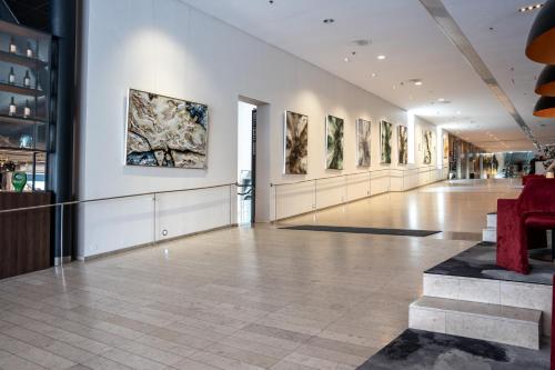 a hallway with paintings on the walls of a building at Clarion Hotel Stockholm in Stockholm
