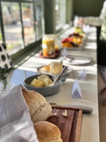 a long buffet with bread and other foods on a table at Kilima Gardens in Nanyuki