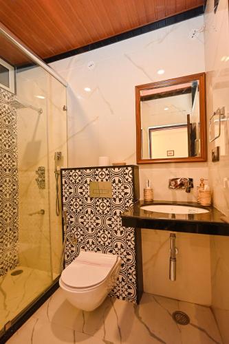 a bathroom with a toilet and a sink and a shower at Harnawa Haveli - A Boutique Heritage Stay in Jaipur