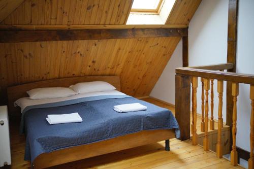 a bedroom with a bed with two towels on it at Край Неба in Slavske