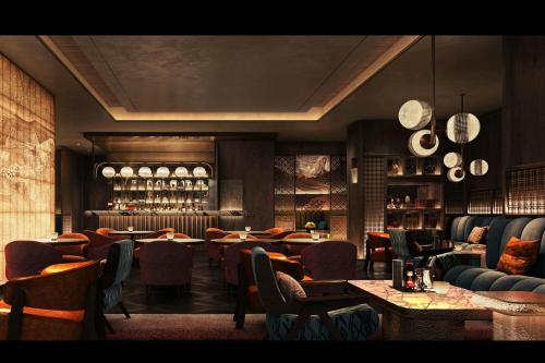 a restaurant with tables and chairs and a bar at JW Marriott Hotel and Suites Saigon in Ho Chi Minh City