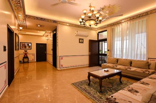 a living room with a couch and a table at Harnawa Haveli - A Boutique Heritage Stay in Jaipur