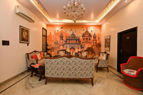 a dining room with chairs and a painting on the wall at Harnawa Haveli - A Boutique Heritage Stay in Jaipur