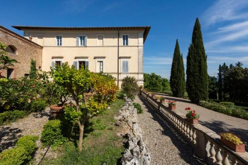 a building with trees and plants in front of it at Borgo Villa Certano - Case Vacanza in Toscana in Siena