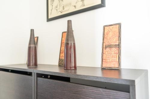 three vases are sitting on top of a dresser at House with pool and garden in Esmoriz near Porto in Esmoriz