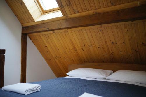 a bedroom with a bed with a wooden ceiling at Край Неба in Slavske