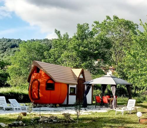 an orange house with a gazebo and chairs at Krka Magic Pumpkin in Rupe