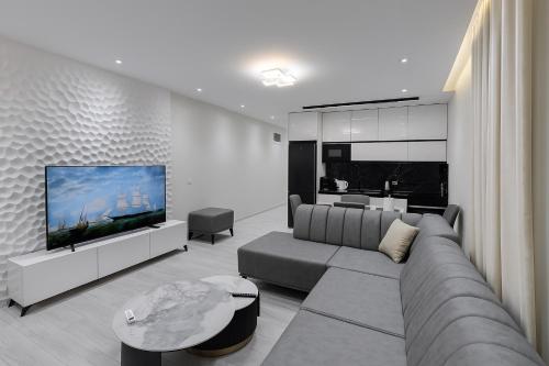 a living room with a couch and a flat screen tv at Eron Villas Velipoje in Velipojë