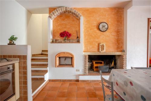 a living room with a brick fireplace and a table at Casa spaziosa per piu' famiglie in Bari Sardo