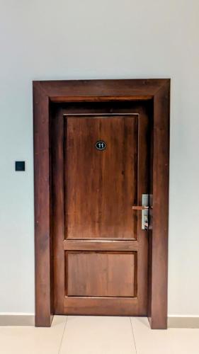 a wooden door in the corner of a room at Royal Lion Hotel - Kandy Road, Galagadara in Galagedara