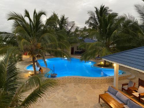an overhead view of a swimming pool with palm trees at Summer Beach Paje in Paje