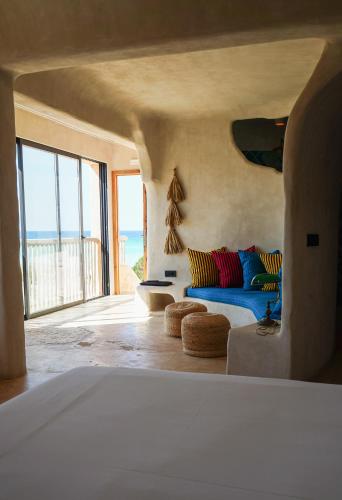 a living room with a couch and a view of the ocean at Hannah Formentera in Playa Migjorn