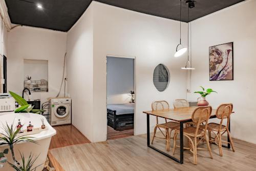 a living room with a dining room table and a bathroom at Saigon Hideout New World View in Ho Chi Minh City