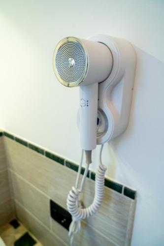 a shower with a light attached to a wall at Agriturismo Le Marognole in Colà di Lazise