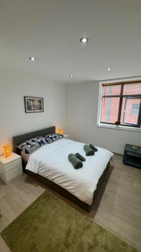 a bedroom with a large bed with pillows on it at Ultra-Central Loft Penthouse Sky Sports & Movies in Leeds