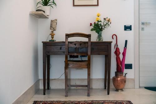 a wooden desk with a chair and an umbrella at Agriturismo Le Marognole in Colà di Lazise