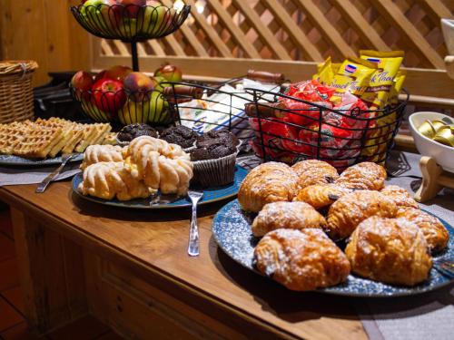a table topped with plates of donuts and other pastries at Gasthaus & Hotel "Zum Boarn" in Rain
