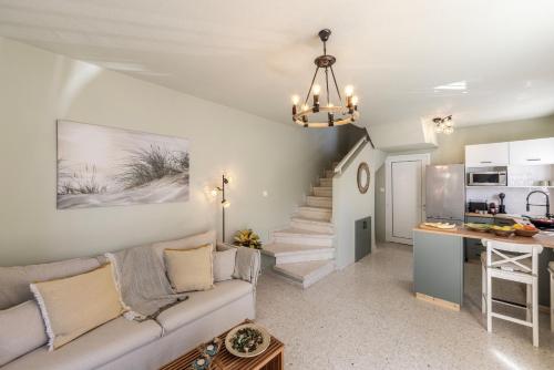 a living room with a couch and a kitchen at Laranca Oneiro Seaside Villa in Perivolia
