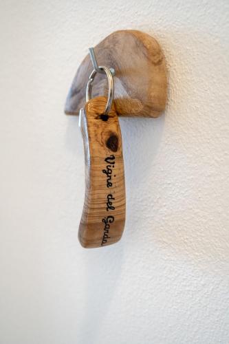 a piece of wood hanging on a wall at Agriturismo Le Marognole in Colà di Lazise