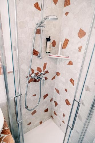 a shower with a glass shower head in a bathroom at Agriturismo Le Marognole in Colà di Lazise