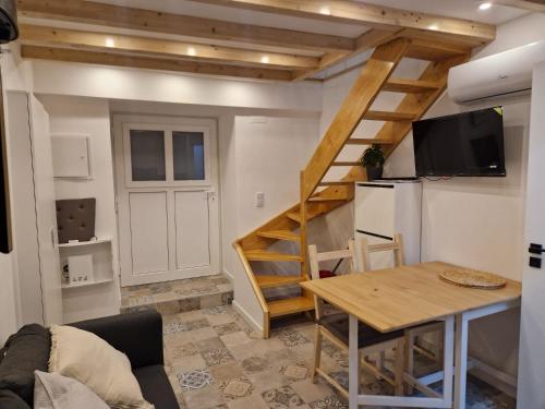 a living room with a staircase and a table and a kitchen at House Lisboa in Lisbon