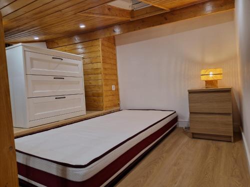 a small bedroom with a bed and a dresser at House Lisboa in Lisbon