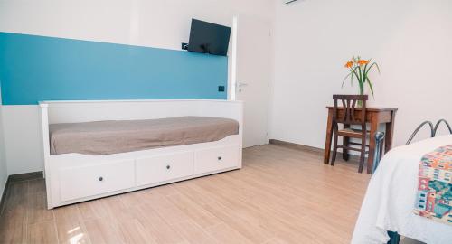 a bedroom with a large white bed and a table at Agriturismo Le Marognole in Colà di Lazise