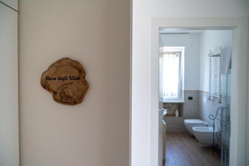 a bathroom with a heart shaped clock on the wall at Agriturismo Le Marognole in Colà di Lazise