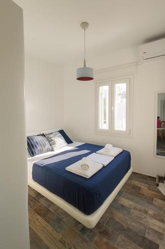 a bedroom with a bed with towels on it at Seafront Alos Gem - Loutra Seaview Escape in Loutra